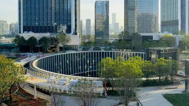 Exterior view from a slightly elevated angle showing a technical roof structure with metal cladding elements and a landscaped roof area during construction.