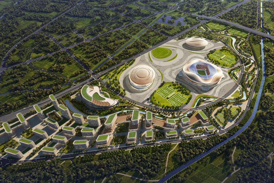 Large-scale aerial rendering of a sports campus with arenas, landscape zones and surrounding developments.